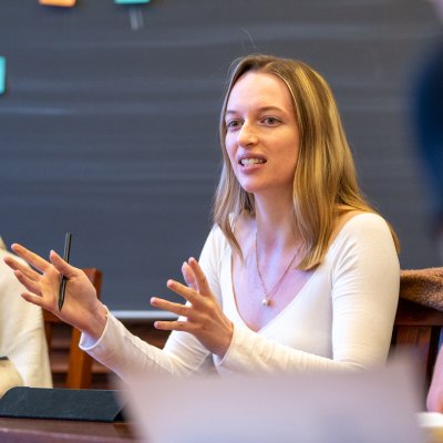 Female students discuss in a seminar setting