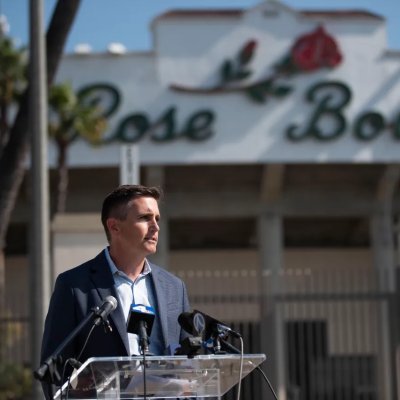 Jens Weiden speaks at a podium with the Rose Bowl stadium and logo in background