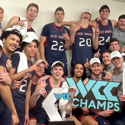 Men's Basketball team holds WCC logo to celebrate in Malibu in February 2024
