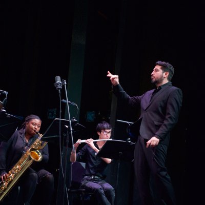 Dr. Sixto F. Montesinos conducting Makaiya Bedford and Michael Welsh with a black background
