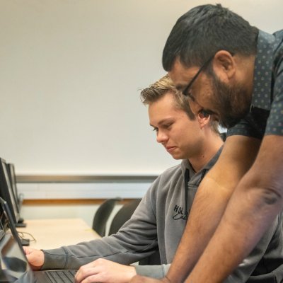 Udayan Das instructing two Computer Science students