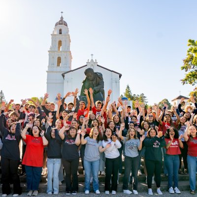 Weekend of Welcome volunteers (WOWies) in front of the chapel, August 2024
