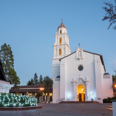 Saint Mary's Chapel at dusk with a lit-up Christmas tree