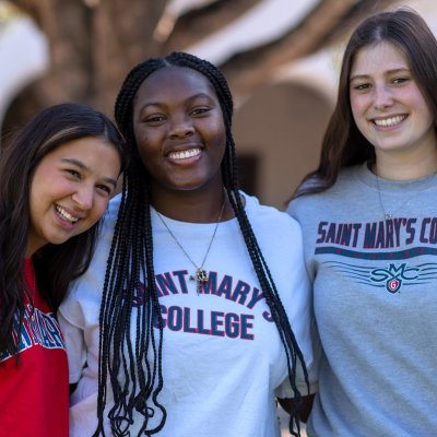 Three female students smiling, at WOWIE weekend 2024
