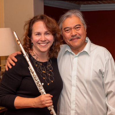 Amy Likar holding her flute with pianist Lino Rivera