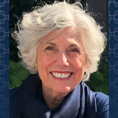 Dr. Maria O'Rourke headshot with a blue patterned background