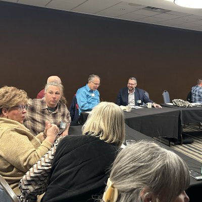 Several people talk while at a conference