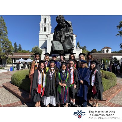 graduation photo of 2025-2026 cohort, blue sky with students in front of SMC chapel