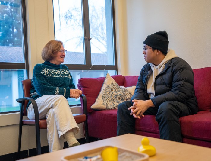 Success Coach and student having a discussion in office lounge