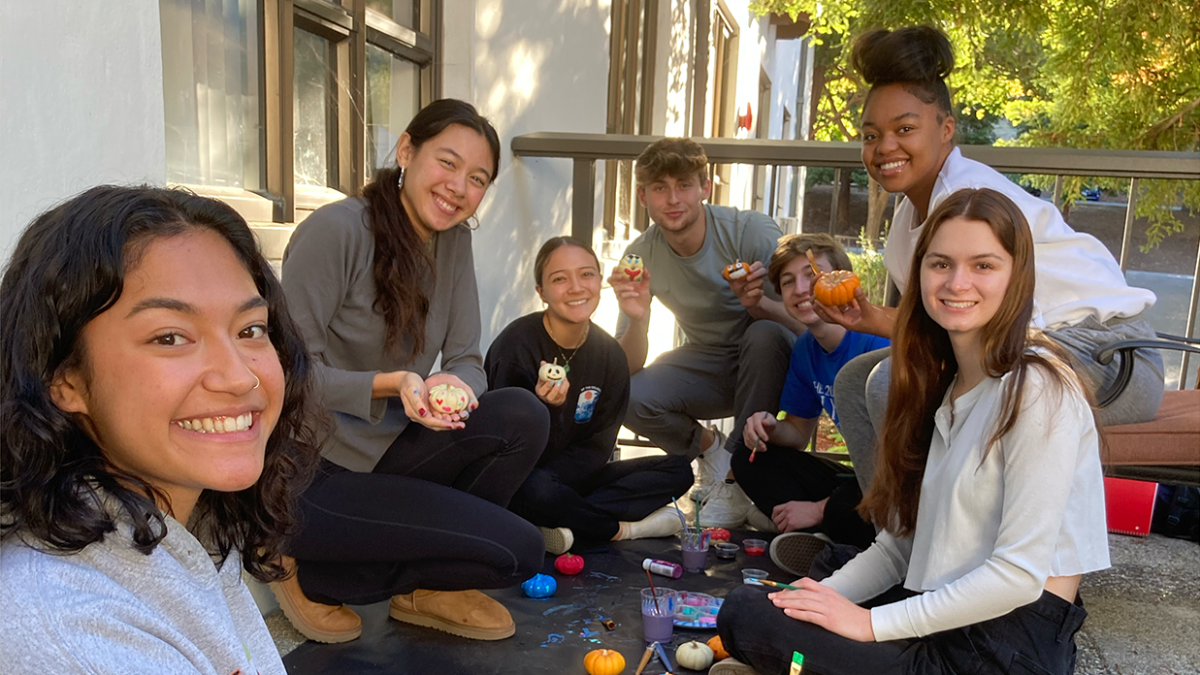 Honors students painting on the Aquinas terrace